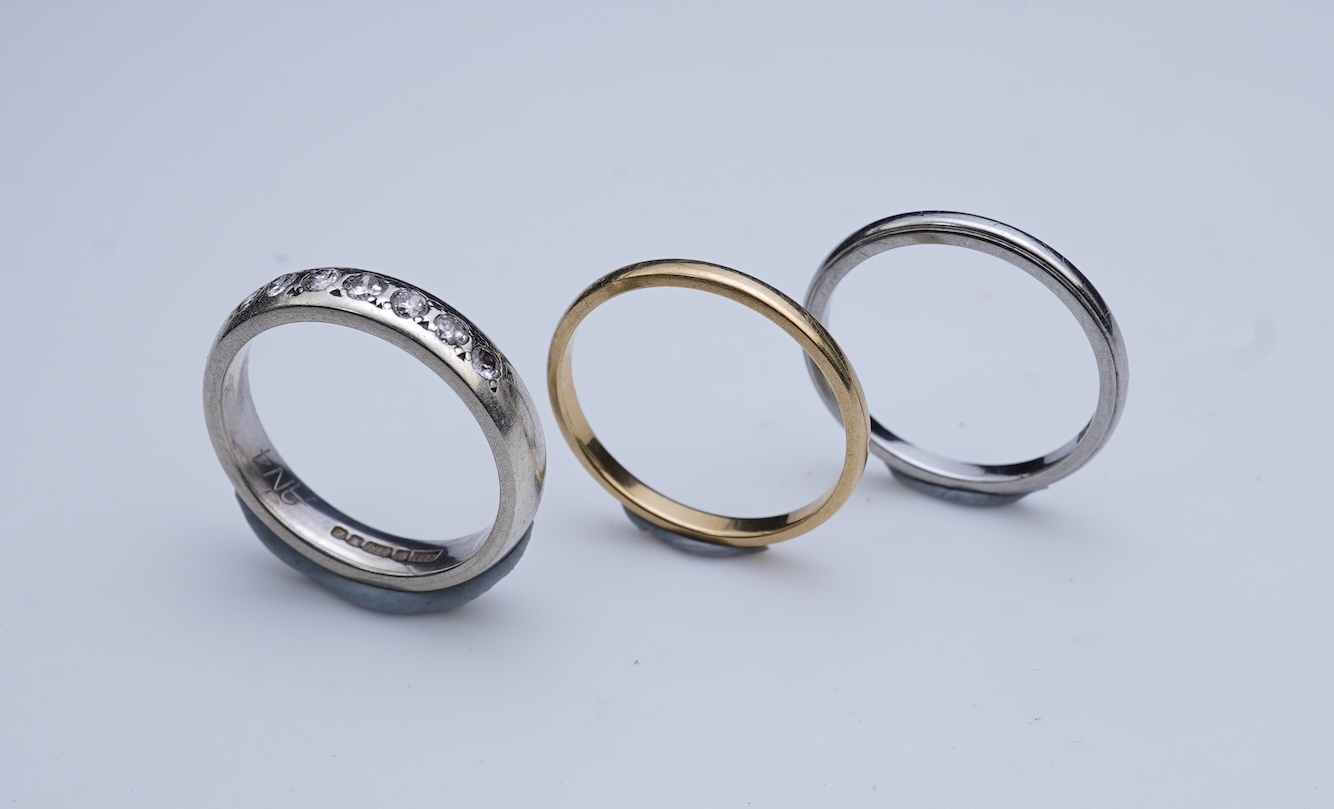 A diamond ring and two gold wedding rings